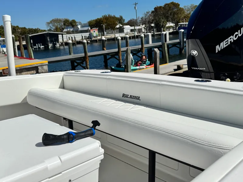 Slide: The Image of Reef Runner 230 c boat at dock, 2026 model. - 18