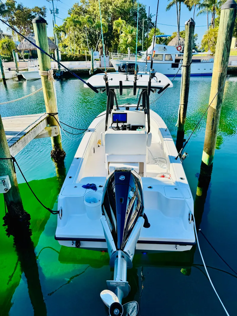 Slide: The Image of Reef Runner 230 c boat 2026 docked, clear water view. - 7