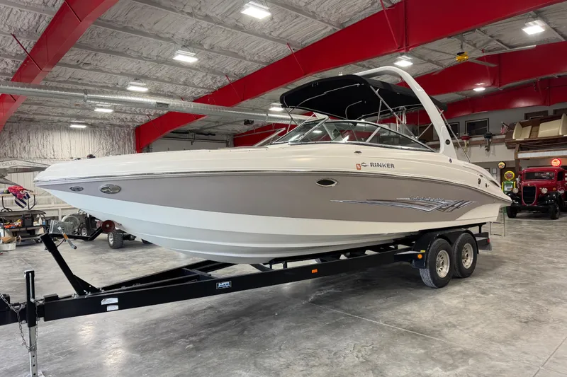 Slide: The Image of 2008 Rinker 296 Captiva Bowrider boat on trailer in indoor showroom. - 1