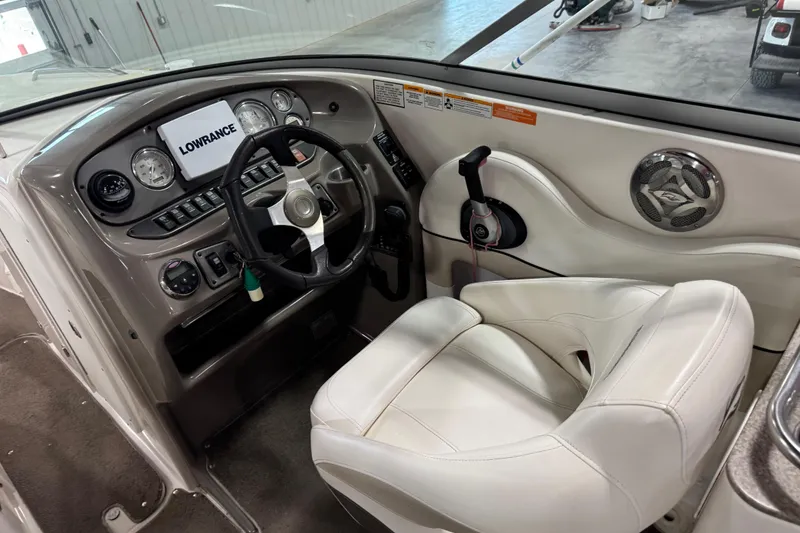 Slide: The Image of 2008 Rinker 296 Captiva Bowrider helm with Lowrance display and white captain's seat. - 10