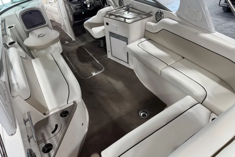 Slide: The Image of 2008 Rinker 296 Captiva Bowrider interior with white seating and modern amenities. - 11