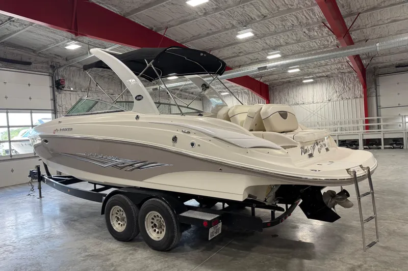 Slide: The Image of 2008 Rinker 296 Captiva Bowrider boat on trailer in indoor storage facility. - 3