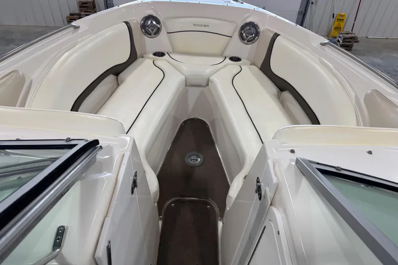Slide: The Image of 2008 Rinker 296 Captiva Bowrider interior with white seating and cup holders. - 8