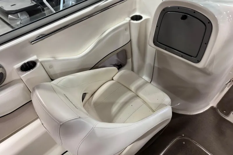 Slide: The Image of 2008 Rinker 296 Captiva Bowrider interior with white seating and cup holders. - 9