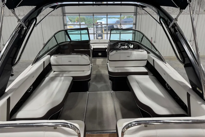 Slide: The Image of 2015 Regal 2800 Bowrider interior with spacious seating and sleek design in a showroom. - 11