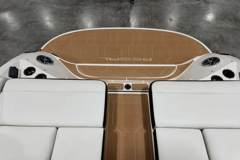 Slide: The Image of 2015 Regal 2800 Bowrider boat interior with white seating and wood finish deck. - 12