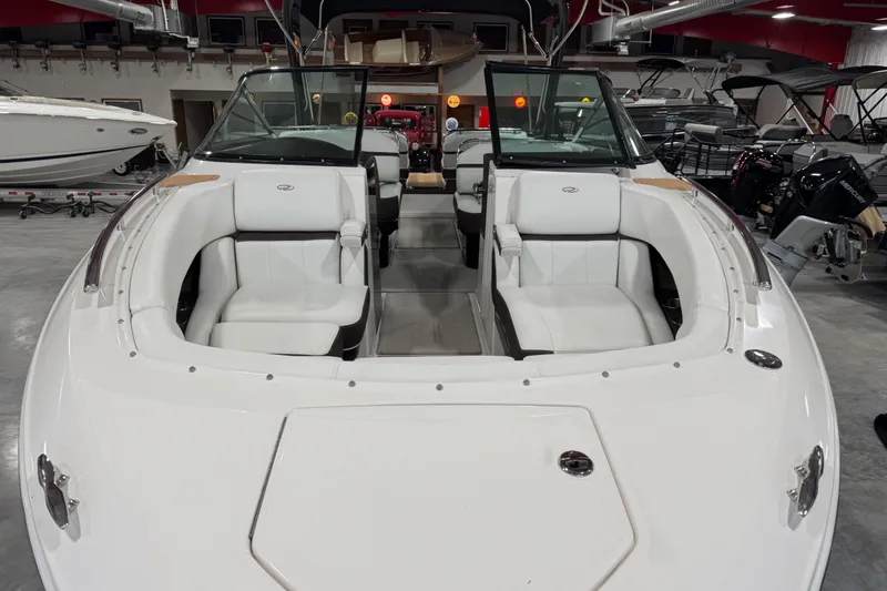 Slide: The Image of 2015 Regal 2800 Bowrider boat with white seating in showroom. - 14