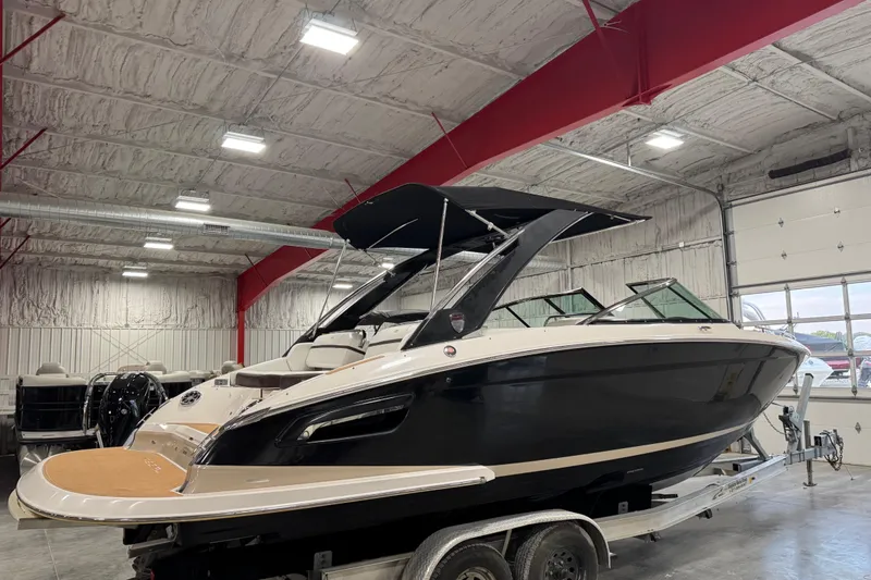 Slide: The Image of 2015 Regal 2800 Bowrider boat in indoor storage on a trailer. - 3