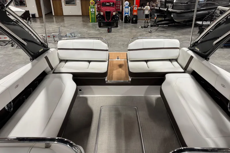 Slide: The Image of 2015 Regal 2800 Bowrider interior with white seating in a showroom setting. - 5