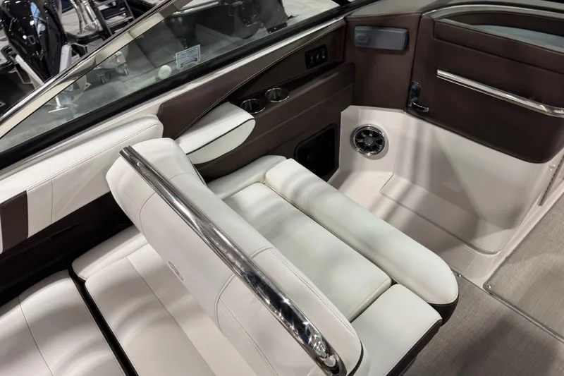 Slide: The Image of 2015 Regal 2800 Bowrider interior with white and brown seating, chrome accents, and cup holders. - 8