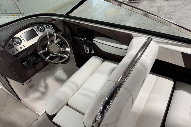 Slide: The Image of Interior of 2015 Regal 2800 Bowrider boat, featuring sleek dashboard and white seating. - 9