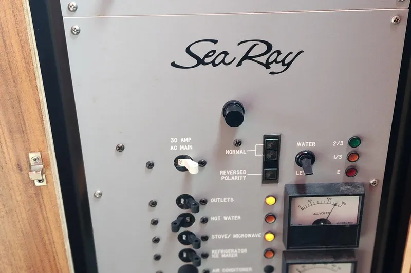 Slide: The Image of Electrical panel of a 1987 Sea Ray 340 Sundancer boat, featuring controls and gauges. - 14