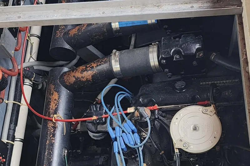 Slide: The Image of Engine compartment of a 1987 Sea Ray 340 Sundancer with visible wiring and components. - 20