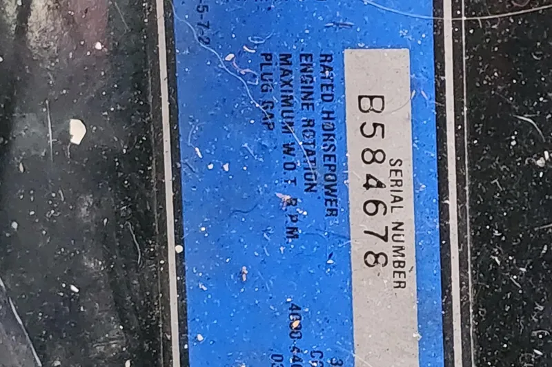 Slide: The Image of Serial number plate of 1987 Sea Ray 340 Sundancer boat, blue background. - 23