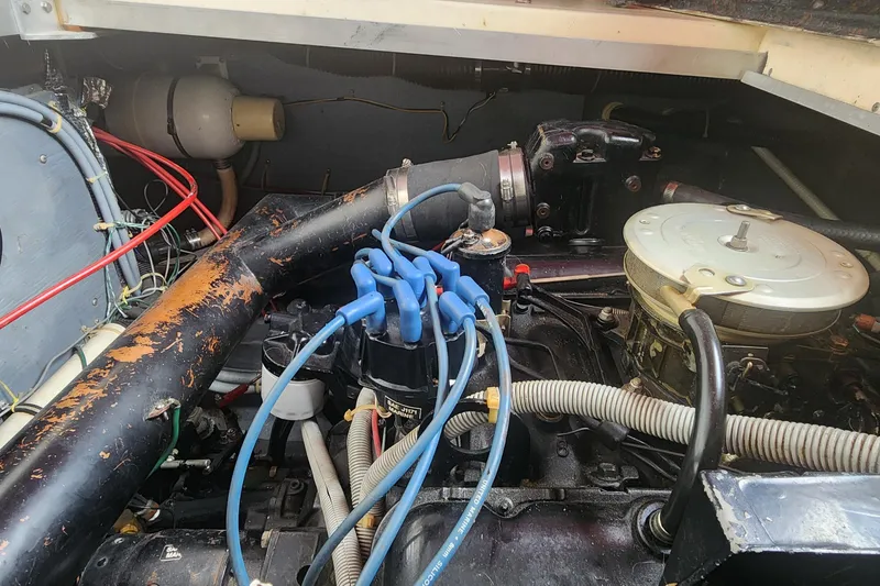 Slide: The Image of Engine compartment of a 1987 Sea Ray 340 Sundancer with visible wiring and components. - 25