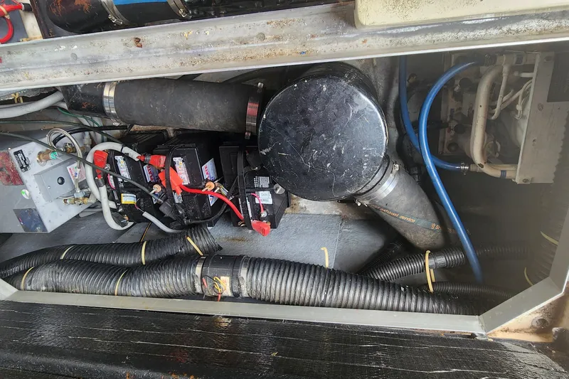 Slide: The Image of Engine compartment of a 1987 Sea Ray 340 Sundancer with visible batteries and wiring. - 26