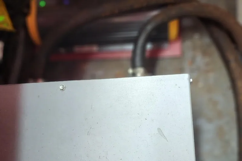 Slide: The Image of Close-up of a metal surface with screws, possibly part of a 1987 Sea Ray 340 Sundancer. - 30