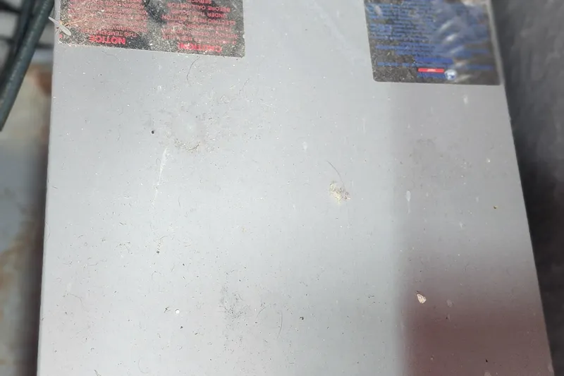 Slide: The Image of Dusty surface with warning labels on a 1987 Sea Ray 340 Sundancer boat component. - 31