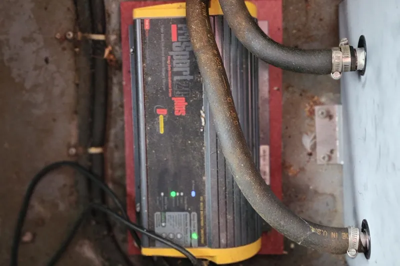 Slide: The Image of Battery charger in 1987 Sea Ray 340 Sundancer engine compartment with hoses and wiring. - 32