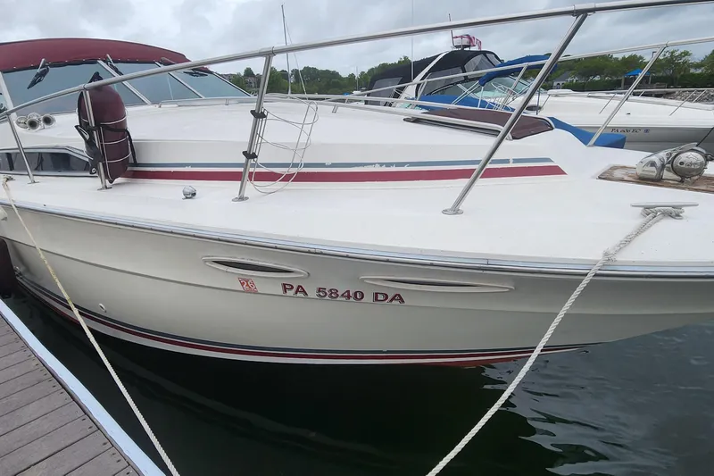 Slide: The Image of 1987 Sea Ray 340 Sundancer docked, featuring maroon accents and registration number PA 5840 DA. - 33