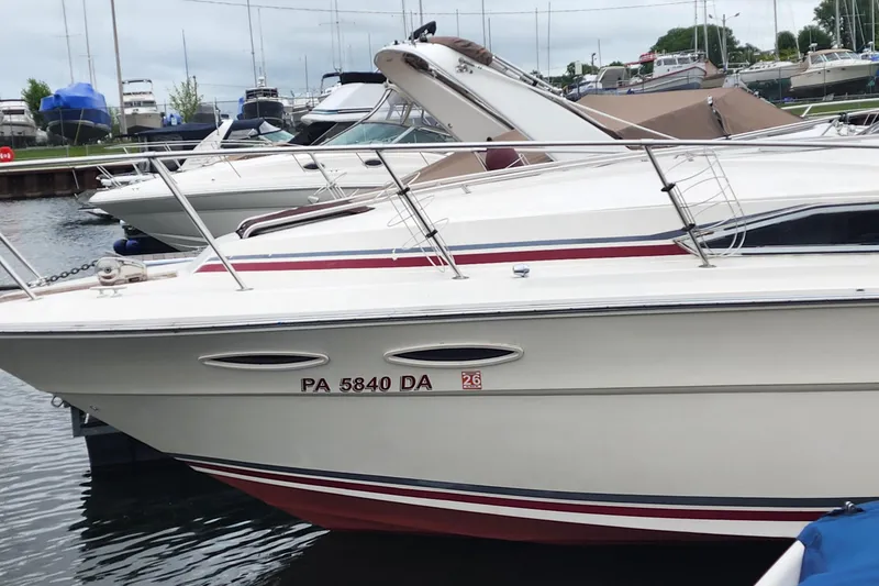 Slide: The Image of 1987 Sea Ray 340 Sundancer docked at marina, featuring sleek design and classic styling. - 34