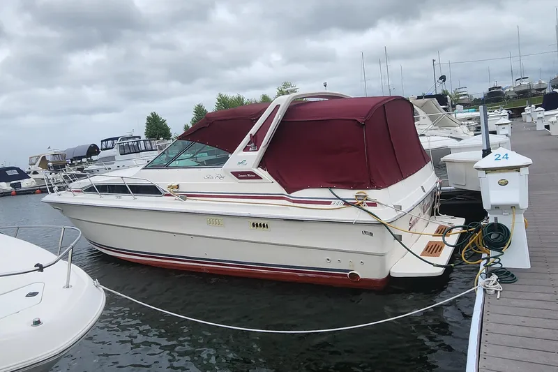 Slide: The Image of 1987 Sea Ray 340 Sundancer docked at marina with burgundy canopy. - 37