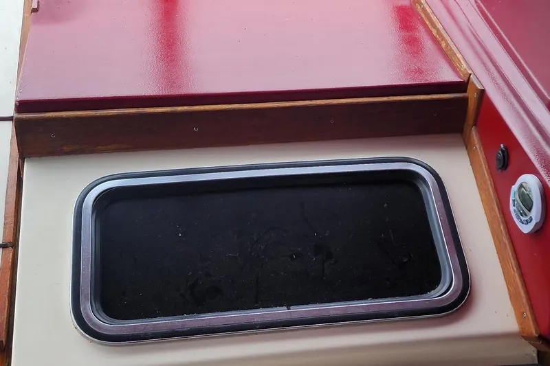 Slide: The Image of 1987 Sea Ray 340 Sundancer boat interior detail with red and beige surfaces. - 6