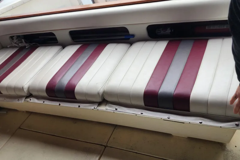 Slide: The Image of 1987 Sea Ray 340 Sundancer boat interior with striped seating. - 9
