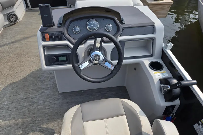 Slide: The Image of 2023 Godfrey Sweetwater 2086 CX boat dashboard with steering wheel and controls. - 3