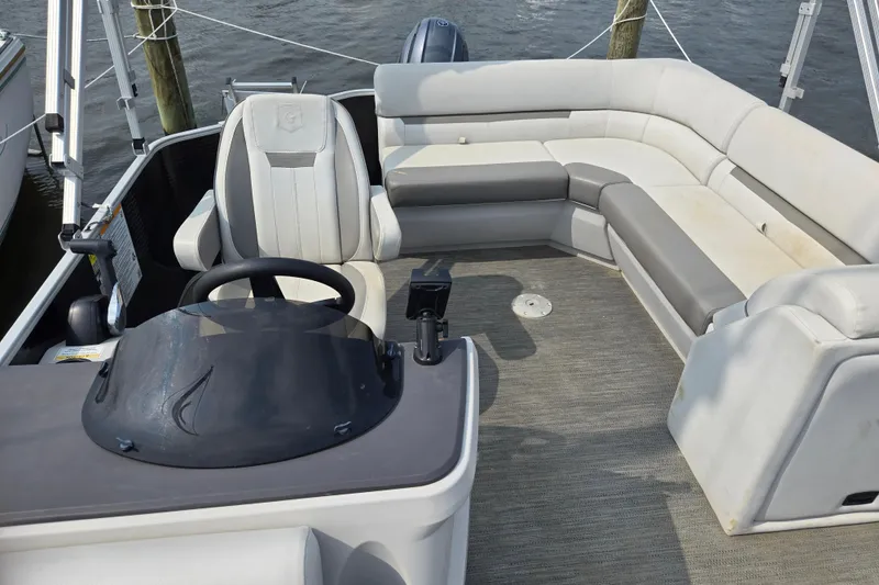 Slide: The Image of 2023 Godfrey Sweetwater 2086 CX pontoon boat interior with helm and seating area. - 5