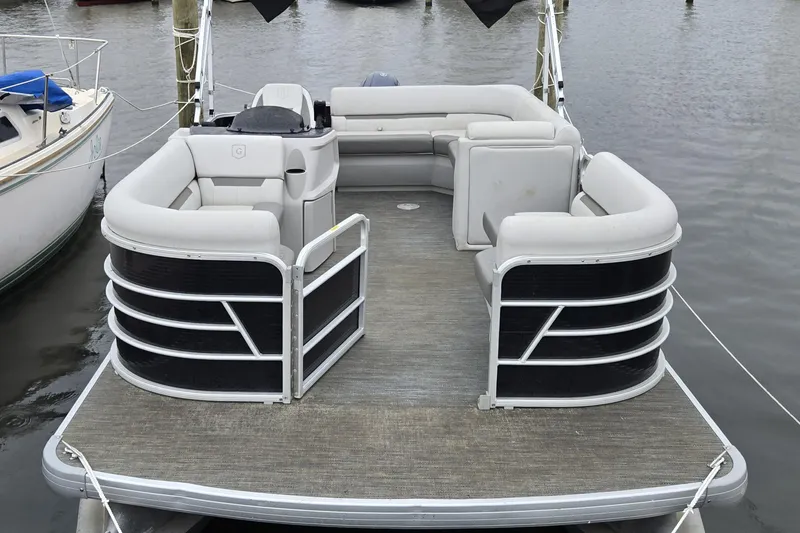 Slide: The Image of 2023 Godfrey Sweetwater 2086 CX pontoon boat with spacious seating, docked on calm water. - 6