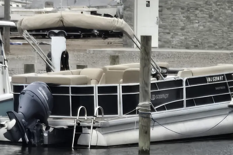 Slide: The Image of 2023 Godfrey Sweetwater 2186 C pontoon boat docked with outboard motor. - 4