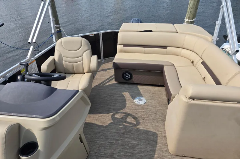 Slide: The Image of 2023 Godfrey Sweetwater 2186 C pontoon boat interior with beige seating and steering console. - 5