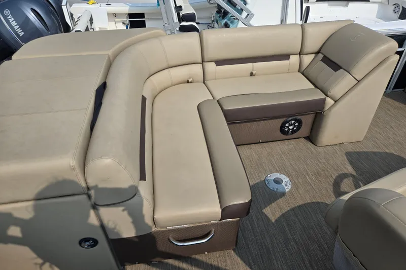 Slide: The Image of 2023 Godfrey Sweetwater 2186 C boat interior with beige seating and Yamaha engine. - 6