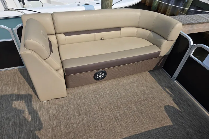 Slide: The Image of 2023 Godfrey Sweetwater 2186 C pontoon boat seating with beige upholstery and integrated speaker. - 9