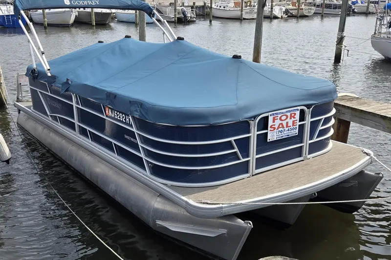 The Image of 2023 Godfrey Sweetwater 2286 SBX pontoon boat for sale at marina dock. - 0