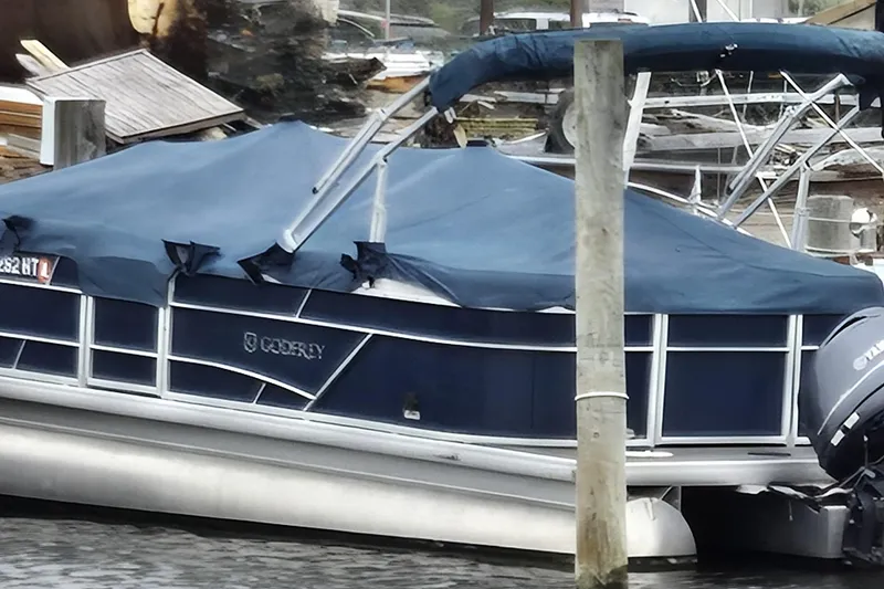 Slide: The Image of 2023 Godfrey Sweetwater 2286 SBX pontoon boat docked with blue cover. - 1