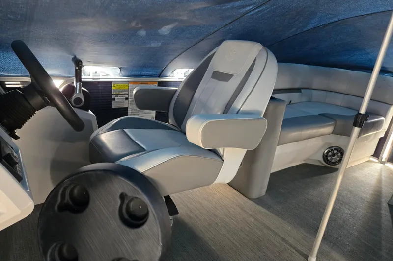 Slide: The Image of 2023 Godfrey Sweetwater 2286 SBX interior with steering wheel and seating under canopy. - 10