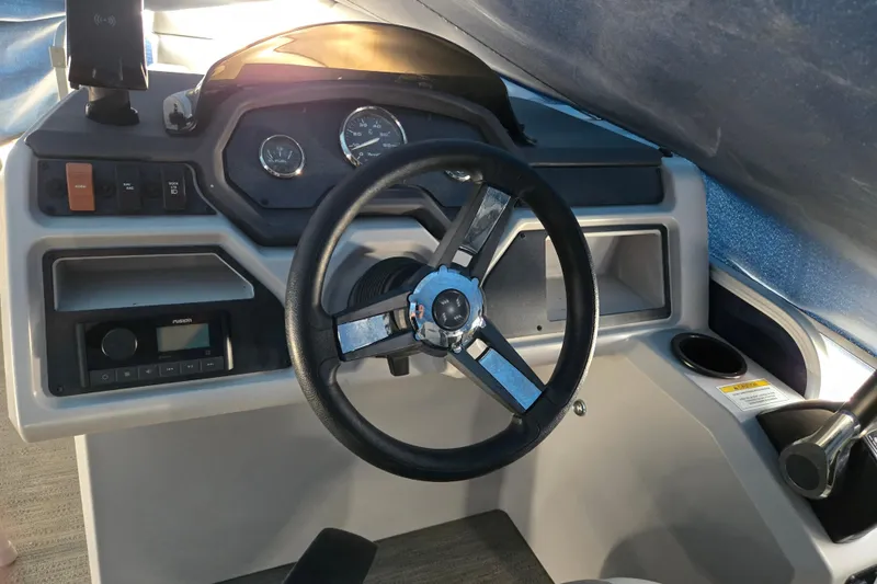 Slide: The Image of 2023 Godfrey Sweetwater 2286 SBX boat dashboard with steering wheel and control panel. - 11