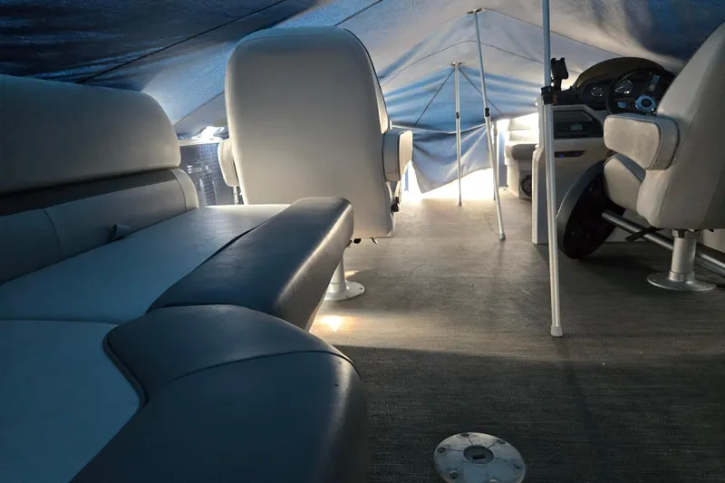Slide: The Image of Interior of 2023 Godfrey Sweetwater 2286 SBX pontoon boat under a tarp. - 12