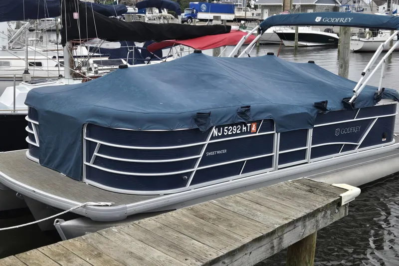 Slide: The Image of 2023 Godfrey Sweetwater 2286 SBX pontoon boat docked with blue cover. - 5