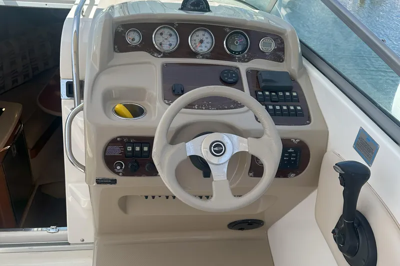 Slide: The Image of 2007 Chaparral Signature 250 boat dashboard with steering wheel and control panel. - 10