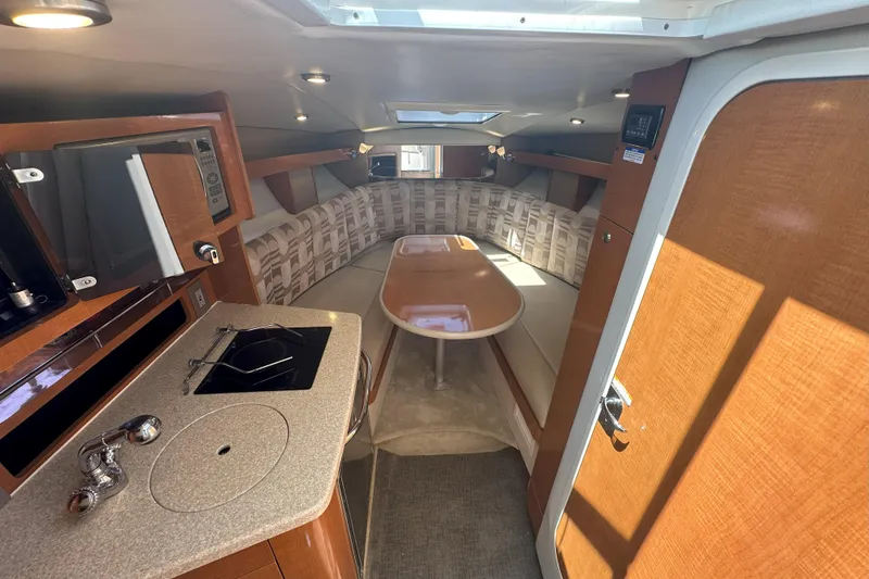 Slide: The Image of Interior of 2007 Chaparral Signature 250 boat with kitchenette and seating area. - 13