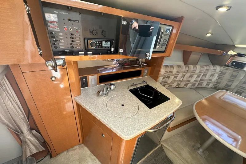 Slide: The Image of 2007 Chaparral Signature 250 cabin interior with kitchenette and seating area. - 14