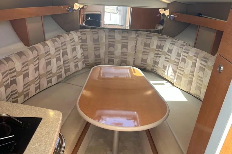 Slide: The Image of 2007 Chaparral Signature 250 interior with patterned seating and wooden table. - 15