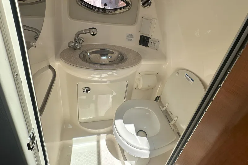 Slide: The Image of 2007 Chaparral Signature 250 boat bathroom with sink and toilet. - 16
