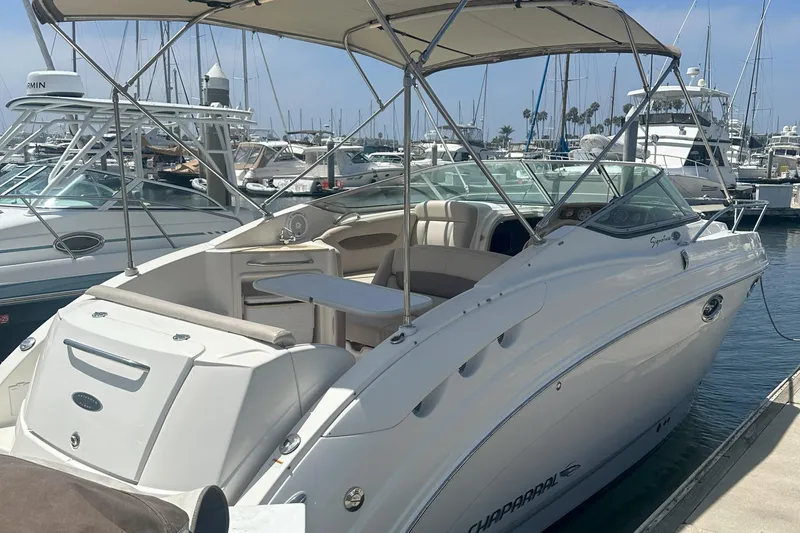 Slide: The Image of 2007 Chaparral Signature 250 boat docked at marina, featuring spacious deck and canopy. - 2