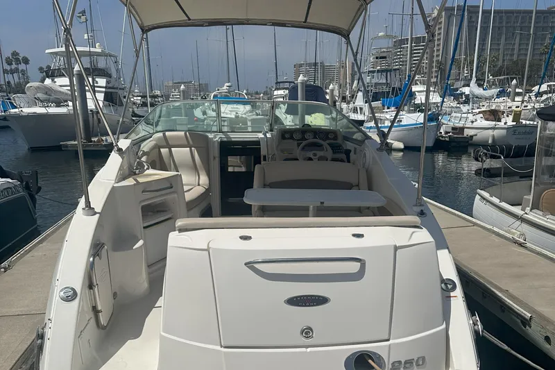 Slide: The Image of 2007 Chaparral Signature 250 boat docked at marina, featuring spacious seating and helm. - 5