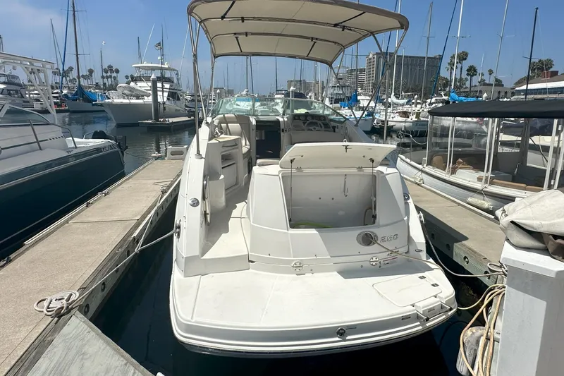 Slide: The Image of 2007 Chaparral Signature 250 boat docked at marina, featuring open deck and canopy. - 8