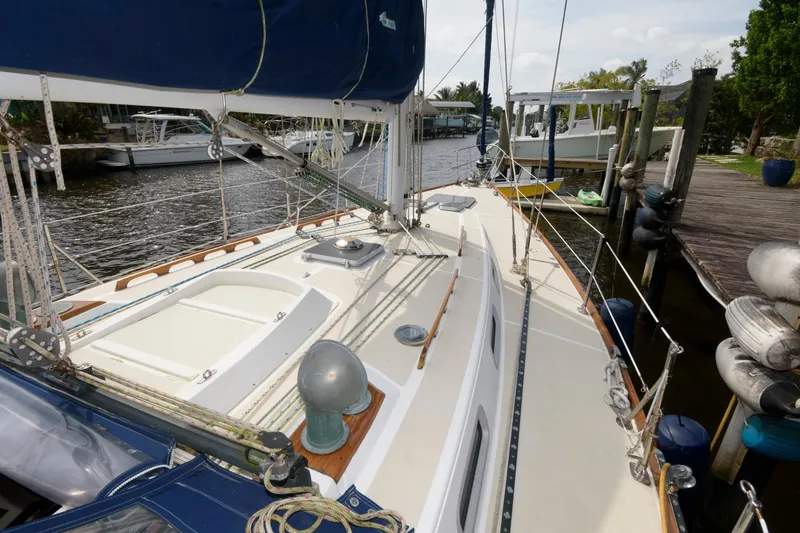 Slide: The Image of 1985 Tartan 40 sailboat docked at a marina. - 11